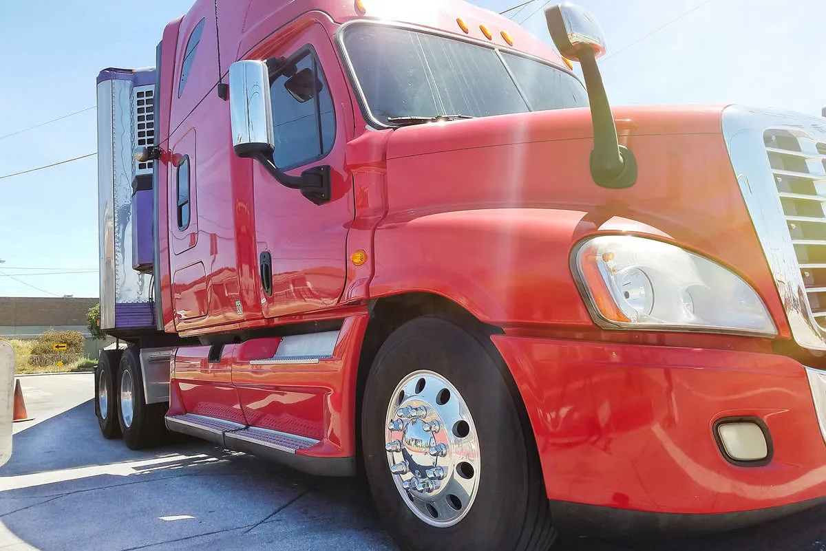 Semi truck load under legal height clearance overhead sunset highway background